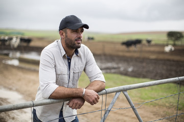 Farmer leaning on farm gate