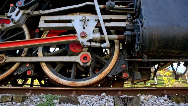 Steam train wheels on tracks closeup
