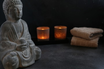buddah witn candle and towel spa concept