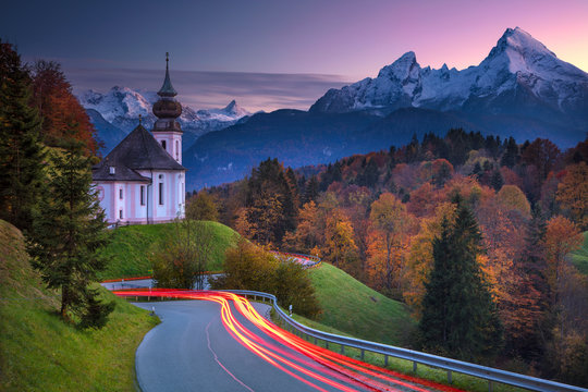 Autumn in Alps. Image of  the european Alps with Maria Gern Church during beautiful autumn sunset.