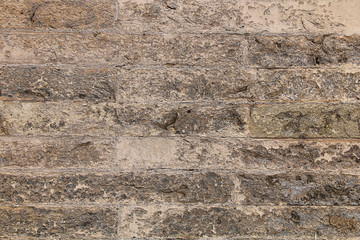 Texture - a wall of very old crumbling stones