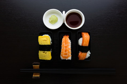 Sashimi fish, shrimp and egg set on the black plate