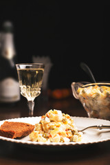 Traditional russian salad olivie and glass of wine