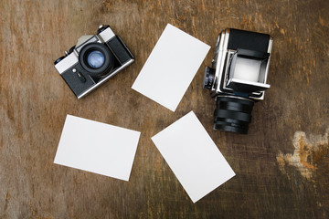 Vintage retro film photocameras on texture wood with print mock up