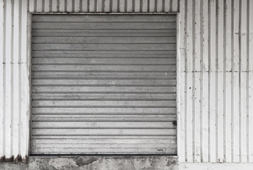 Metal warehouse wall with closed gate