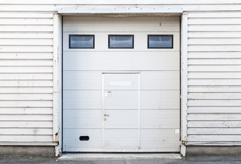 White warehouse wall with closed gate