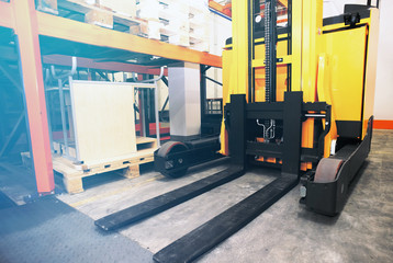 Shelves, racks and forklift  with pallets in distribution wareho