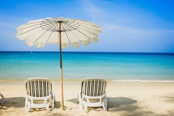 white chairs and umbrella on the beach and calm ocean view 
