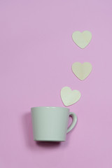 Coffee cup with heart wooden shape on pink background,coffee con