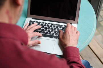 Aged man using his laptop