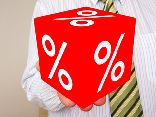 Man holds cubes with percent sign