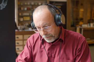 Aged man listening to music
