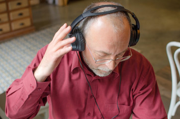 Aged man listening to music