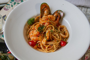 spaghetti sea food on white plate.