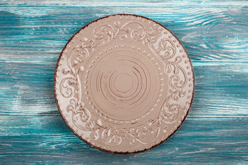Empty plate over wooden table