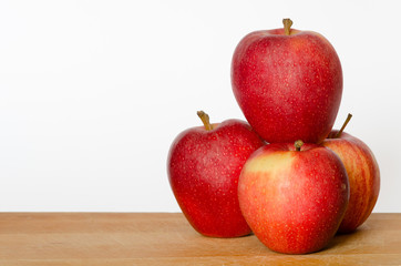 pile of red apples on a chopping board with white background