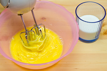 Beaten Eggs with Mixer Whisks in Bowl