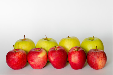 red and yellow apple in line with white background