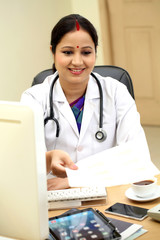 Young female doctor giving patient documents