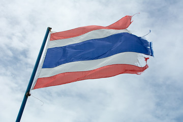 Old Thailand flag against blue sky