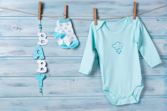 Baby clothes and word baby on a clothesline