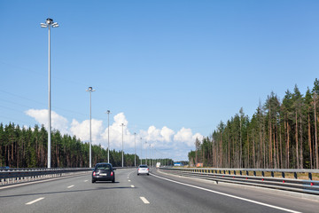 Wide multilane Ring Road in the forest at summer season, highway around the city, St. Petersburg,...