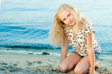 Girl on the sand near the water