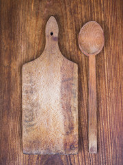 wooden cutting board and spoon on a wooden background

