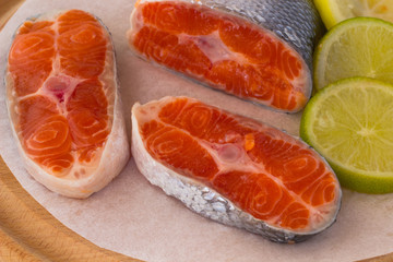 Three Piece of raw salmon and two slices of lemon