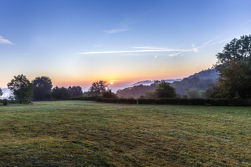 Obraz premium sunrise in german countryside with hills in the Eifel