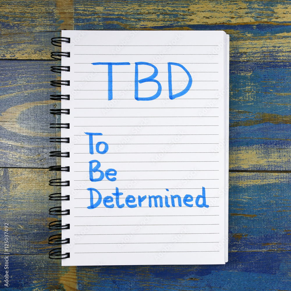 Poster tbd- to be determined text written in notebook on wooden background