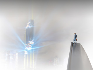 Toy businessman / View of miniature toy, businessman standing on monitor with night city background.