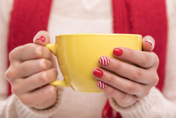 Women's hands holding a cup of drink.