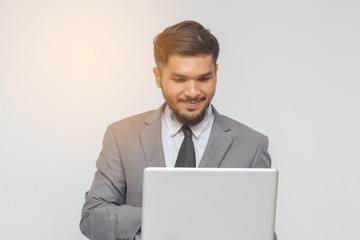 business man with laptop on gray background