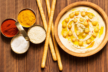Hummus on a wooden background, soft focus, horizontal, top view