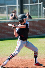 Teenage baseball player at bat