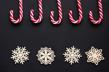 Christmas candy with white snowflake on black background. Christmas background. Top view and copy space.