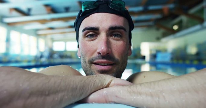 nice attractive and young man in the empty swimming pool in slow motion