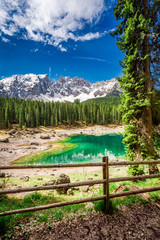 Fototapeta na wymiar Beautiful view to mountain Carezza lake in spring, Alps, Italy
