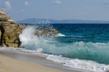 Sea surf and water splashes on the beach