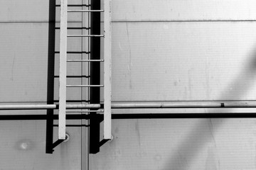 Black and white Ladder on grey wall. © pavelalexeev