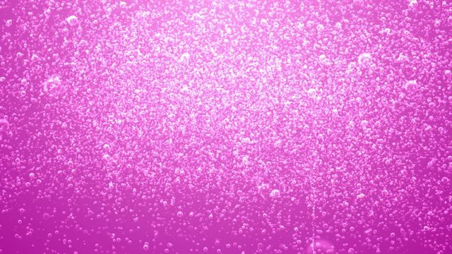 A pink background of extra soda bubble fizz with last 10 seconds loop at end.