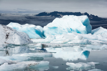 Fototapeta na wymiar Iceberg floating in still waters