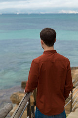 Fototapeta premium Young man looking at sea