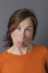 funny middle aged woman with playful eyes and tongue stuck