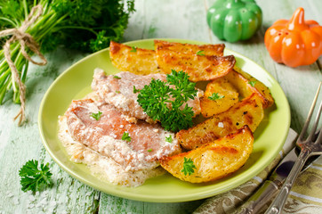 Pork chops with sour cream and baked potatoes