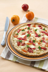 Tart with salted sheep cheese and tomatoes