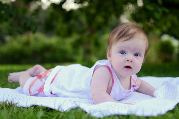 Little baby girl lying in the grass