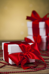 Beautiful gift box with red ribbon on Christmas background