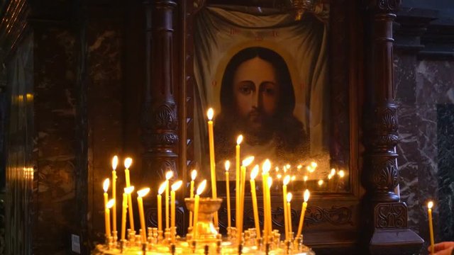Many Candles Are Lit in the Temple of Orthodoxy Before the Holy Image of Christ